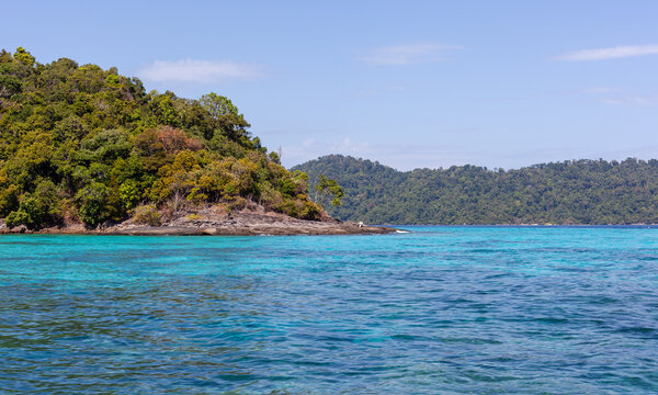 Koh Surin, Thailand. Tropical island with lush greenery. Turquoise Andaman Sea waters. Scenic coastal landscape.
