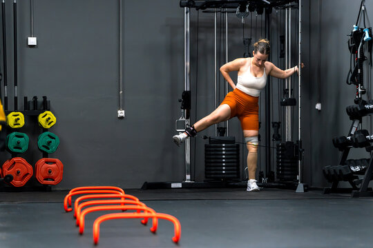 Woman with prosthetic leg exercising in gym for fitness and self-improvement