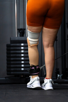 Person with prosthetic leg training in gym, showing self-improvement and dedication