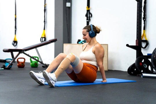 Woman with disability exercising in gym, embracing self-improvement and athletic effort