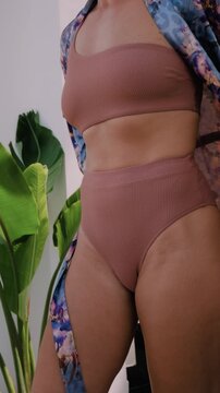 Close up of woman wearing luxury kimono robe over  swimsuit.