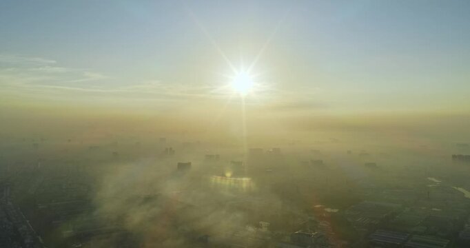 Aerial view of Saigon cityscape at morning with misty sky in Southern Vietnam. Urban development texture, transport infrastructure and green parks
