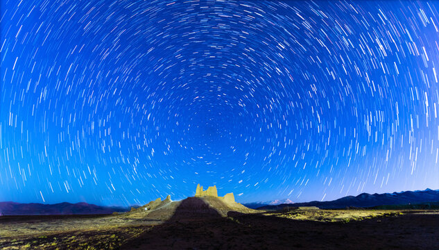 Himalayan peaks and star trails above Peiku Tso in Shigatse, Tibet Autonomous Region, China.