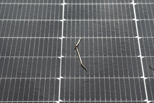 Properly angled solar panel showing clean surface without water drops and smooth water runoff at the edge.