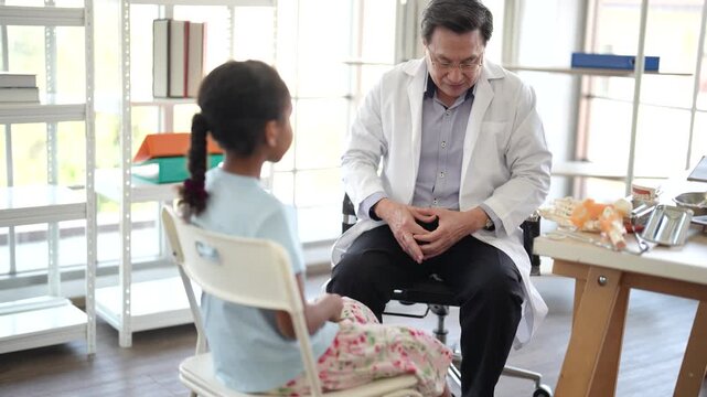 Physician examining child with leg injury in clinic, pediatric orthopedic care, medical assessment, healthcare consultation, physical examination, hospital workflow.