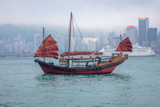 Traditional Junk and a Foggy Hong Kong Waterfront