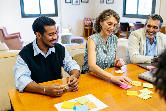 Professional group collaborating on a project, sharing concepts during a business meeting in a modern office environment