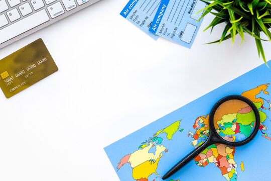 booking trip with map and tourist outfit on white office desk background top view mockup