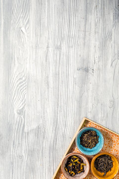 Different kinds of herbal tea on wooden background top view mockup