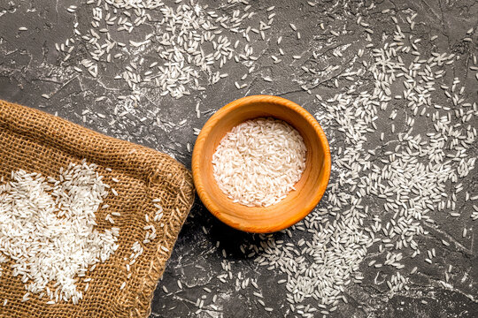 homemade paella ingredients composition with rice in bowl on dark table background top view mock-up