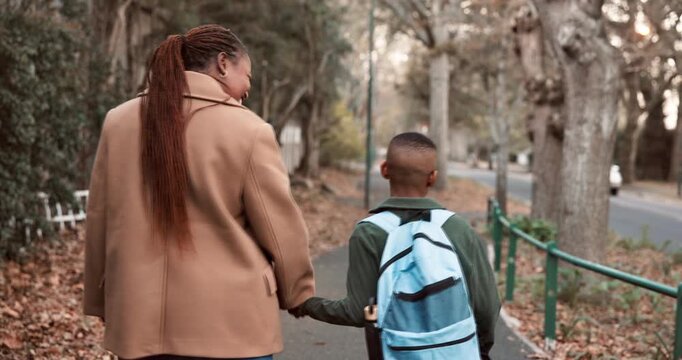 Mother, walk and holding hands outdoor with school child, connection and support for education goals. Back, happy black woman and son in neighborhood with safety, bonding and commute to academy.