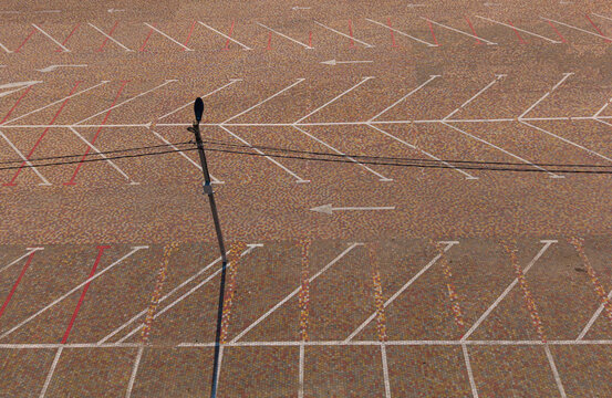Parking lot top down aerial drone view with white marking lines and pavement texture, urban infrastructure concept