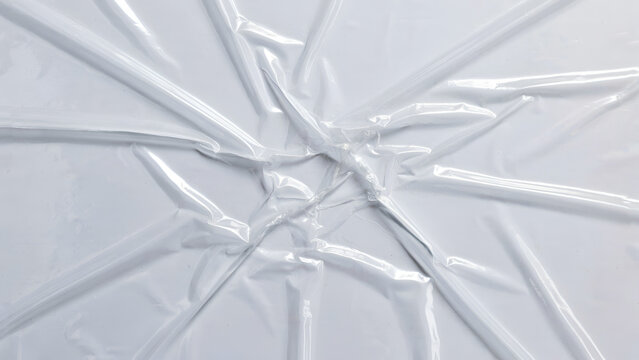 Crinkled cellophane wrap with radial lines during bright studio lighting for abstract texture concepts