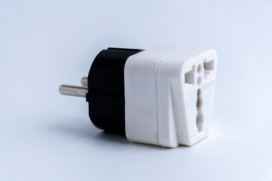 White universal electrical plug adapter isolated on a white background