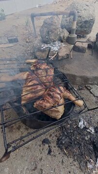 Grilled Chicken Cooking Over Charcoal Outdoors
