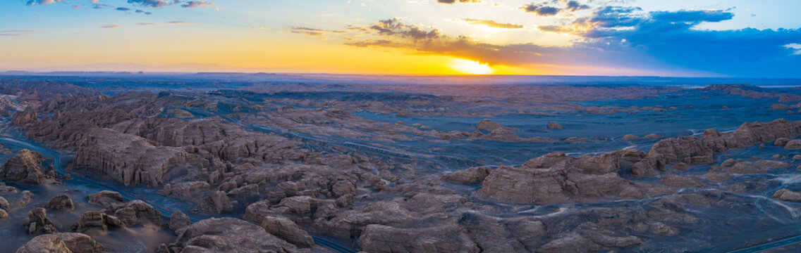 Aerial view of majestic yardang landforms in Gobi Desert at sunset, Dahaidao, Xinjiang, China