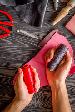 work in leather shop on dark wooden background top view