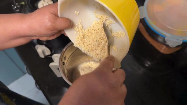 Putting urad dal in the grinder