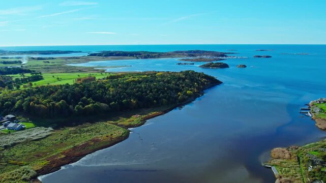 Scenic aerial view of the west coast landscape near Kungsbacka in Halland, Sweden, featuring lush green fields, coastlines, and Vallda Sand&ouml; visible in the distance.