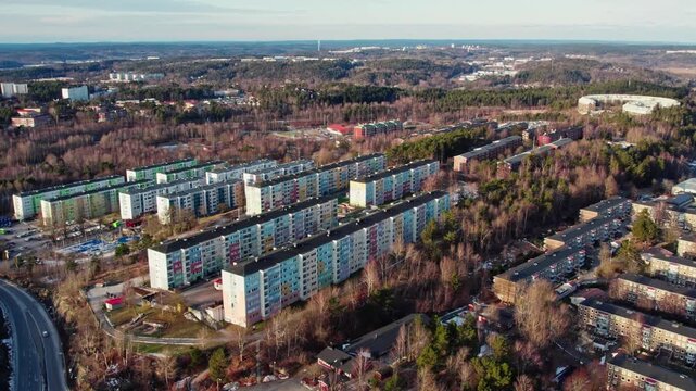 Residential apartment buildings along Siriusgatan in the suburban district of Bergsj&ouml;n, Gothenburg, Sweden, during the winter season with bare trees and clear sky, aerial drone view.