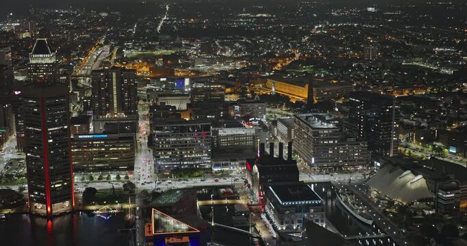 Baltimore Maryland Aerial v76 birds-eye night flyover above Inner Harbor, revealing illuminated downtown streets and waterfront towers - Shot with Inspire 3 8k - Sept 28th 2023