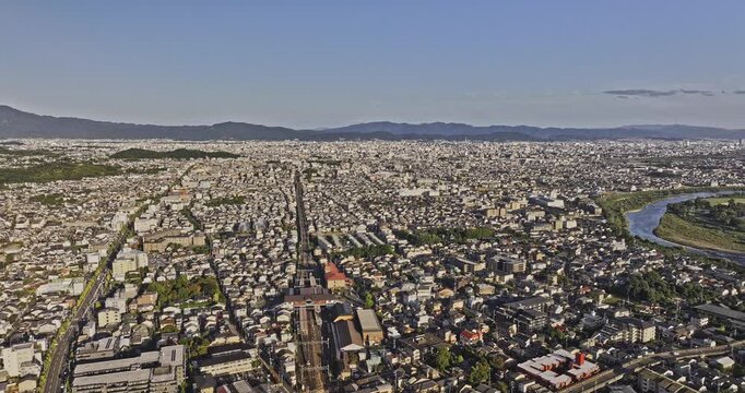 Kyoto Japan Aerial v39 flyover above Saganonomiyacho, revealing residential districts, farmland and green mountain foothills in sunset light - Shot with Mavic 3 Pro Cine - Oct 7th 2023