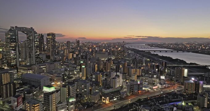 Osaka Japan Aerial v22 flyover above Nakatsu, Oyodonaka and Ofukacho, revealing Kita Ward and Umeda skyline transitioning into night - Shot with Mavic 3 Pro Cine - Oct 8th 2023