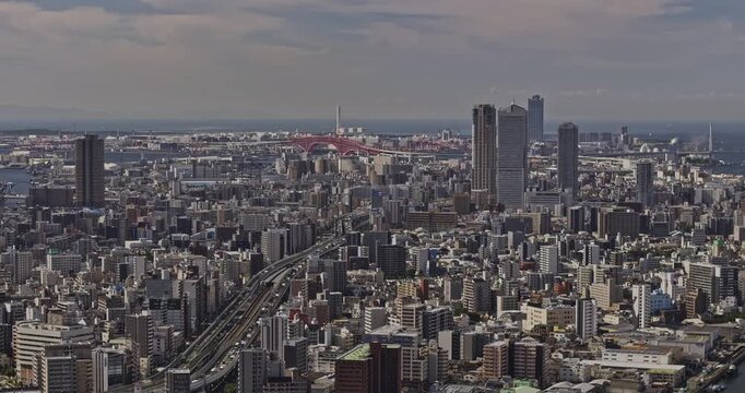 Osaka Japan Aerial v35 telephoto flyover above Tosabori River, revealing dense Nishi and Minato Ward cityscape extending toward Osaka Bay - Shot with Mavic 3 Pro Cine - Oct 9th 2023