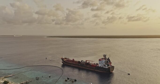 Bonaire Caribbean Netherlands Aerial v40 orbiting sunset flyover above Hato coast, revealing a moored ship, Playa, Kralendijk and Klein Bonaire - Shot with Mavic 3 Pro Cine - Feb 3rd 2024