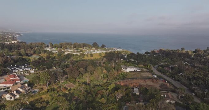 Malibu California Aerial v34 sweeping flyover above central hillside neighborhoods, revealing Paradise Cove Beach and curving Pacific coastline - Shot with Mavic 3 Pro Cine - May 26th 2024