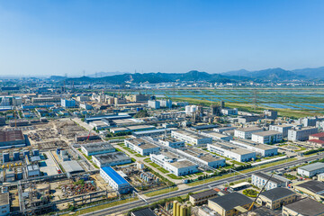 Naklejka premium Aerial drone shot of a modern chemical industrial park with factory buildings and warehouses under blue sky in China