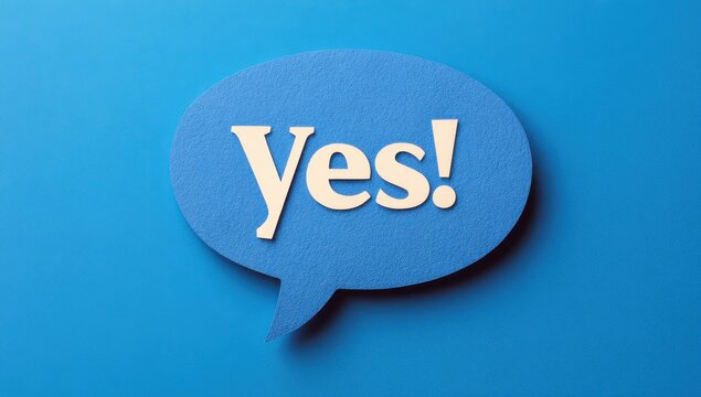 Paper speech bubble with white yes text isolated on blue background communication background affirmation positive agreement decision confirmation approval dialogue minimalist