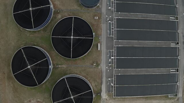 Wastewater treatment plant with circular clarifier tanks, sedimentation, sewage purification and engineering, aerial view.