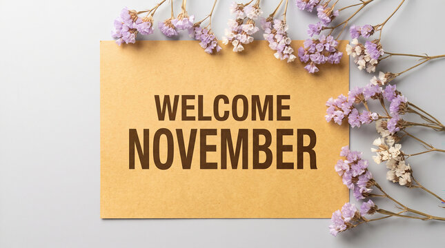 Welcome november text on paper card decorated with purple dried flowers