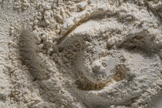 White wheat flour texture closeup. Background of white wheat flour with organic hills, valleys, and shadows