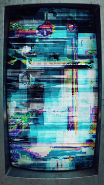 A smartphone with a heavily corrupted and glitching screen display.