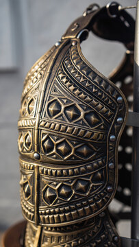 Close-up of an intricately designed metallic armor piece.