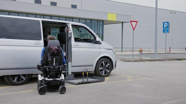 Wheelchair user boarding an adapted van using a platform lift, accessible entry for people with disabilities, and independent mobility.