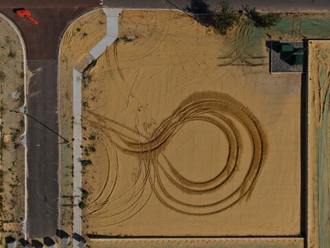 Abstract aerial view of circular tyre tracks on a prepared residential building lot