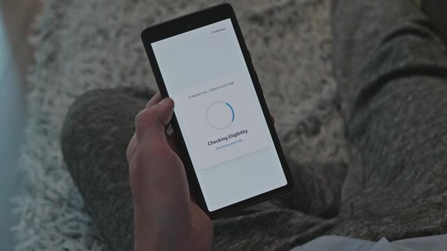 Person using mobile phone application for financial verification and online credit approval to illustrate modern fintech banking instant money lending services