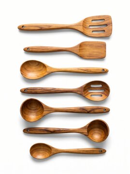 Set of various wooden kitchen utensils including spoons, spatulas, and ladles, isolated on white background