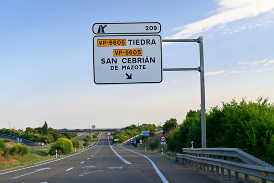 Road sign on the A-6 motorway in Spain, indicating exit 209 towards Tiedra and San Cebri&aacute;n de Mazote, province of Valladolid, Castile and Le&oacute;n, Spain. June 25, 2026