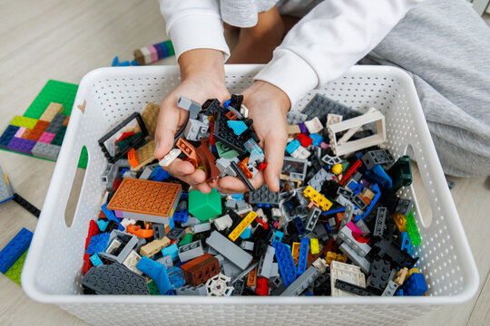 Hands on play with small building block pieces develops fine motor skills, finger dexterity, hand control, concentration and creative thinking during educational activities.