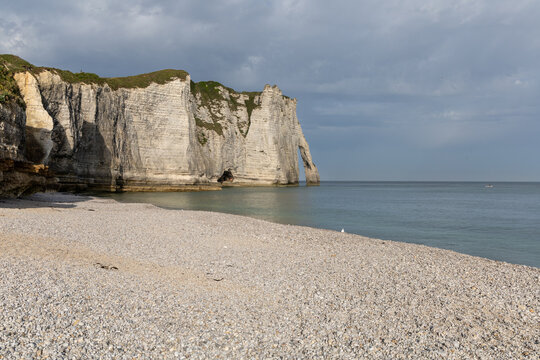 Aval Cliff and natural arch seen from Etretat beach on the Alabaster Coast, Normandy, France