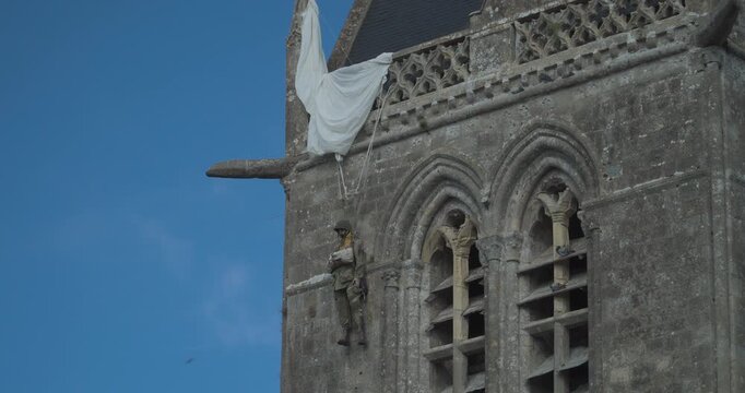 The Church of Sainte-M&egrave;re-&Eacute;glise in Normandy displays a hanging doll, commemorating the American paratrooper John Steele. Normandy, France