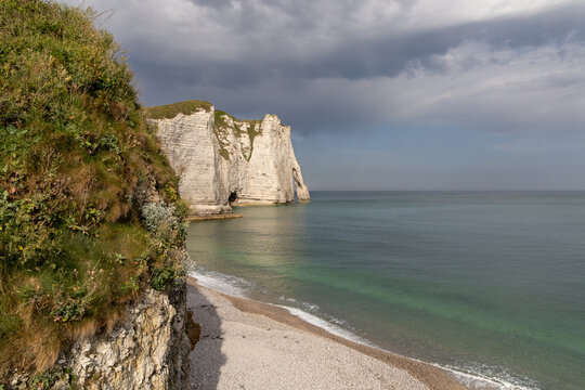 Aval Cliff and natural arch seen from Etretat beach on the Alabaster Coast, Normandy, France