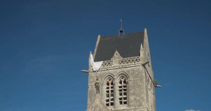 The Church of Sainte-M&egrave;re-&Eacute;glise in Normandy displays a hanging doll, commemorating the American paratrooper John Steele. Normandy, France