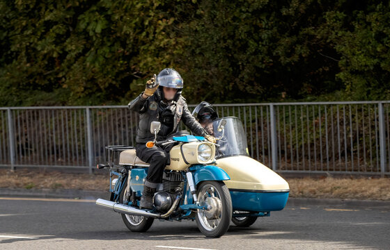 Milton Keynes,UK - Aug 2nd 2026:  Man riding a 1972 MZ Trophy ES250/2 classic motorcycle with Velorex sidecar driving on a British road
