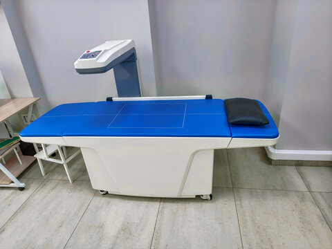 Medical bone densitometer machine in radiology clinic. DXA scan device for osteoporosis diagnosis and bone density measurement. Professional healthcare equipment for orthopedic exam