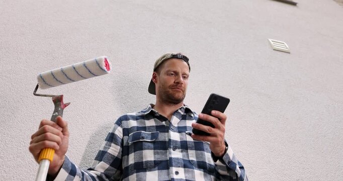 Construction worker receiving new job orders on phone during home renovation. handyman service, online booking